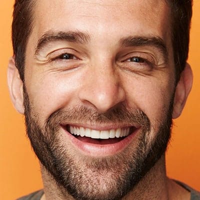 A man with a beard smiling for the camera.